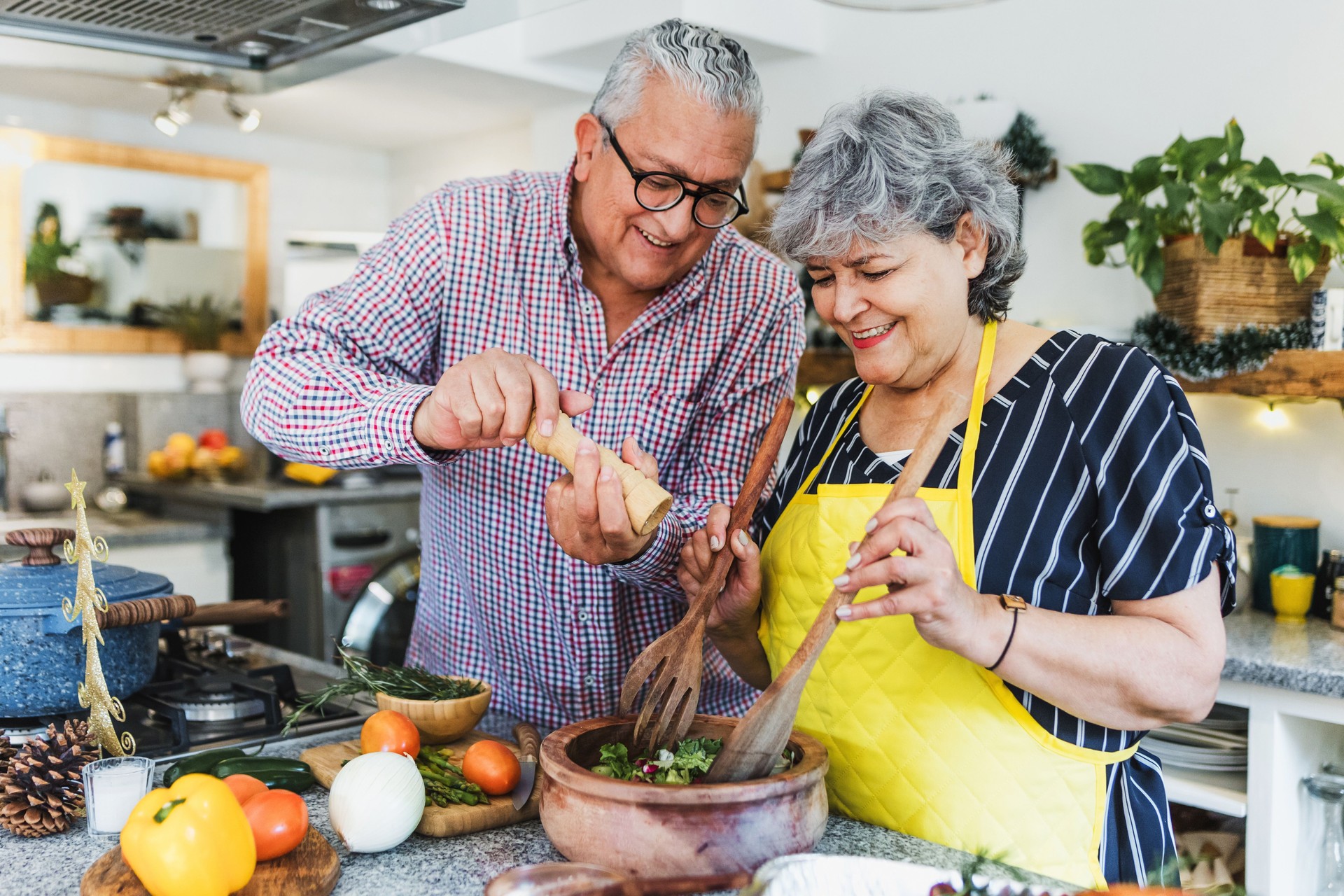 senior couple cooking dinner at home in  Latin America